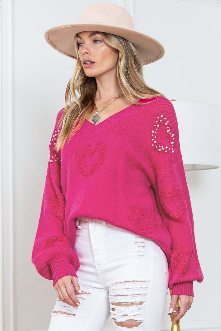 Solène – Pull rose avec col en V et détails en forme de cœur