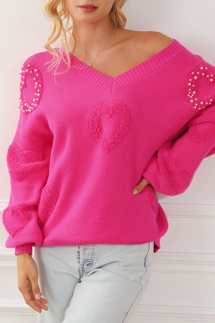 Solène – Pull rose avec col en V et détails en forme de cœur