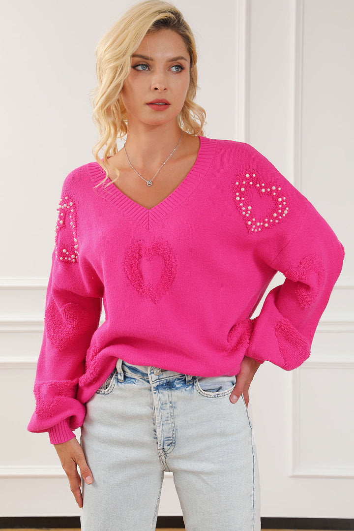 Solène – Pull rose avec col en V et détails en forme de cœur