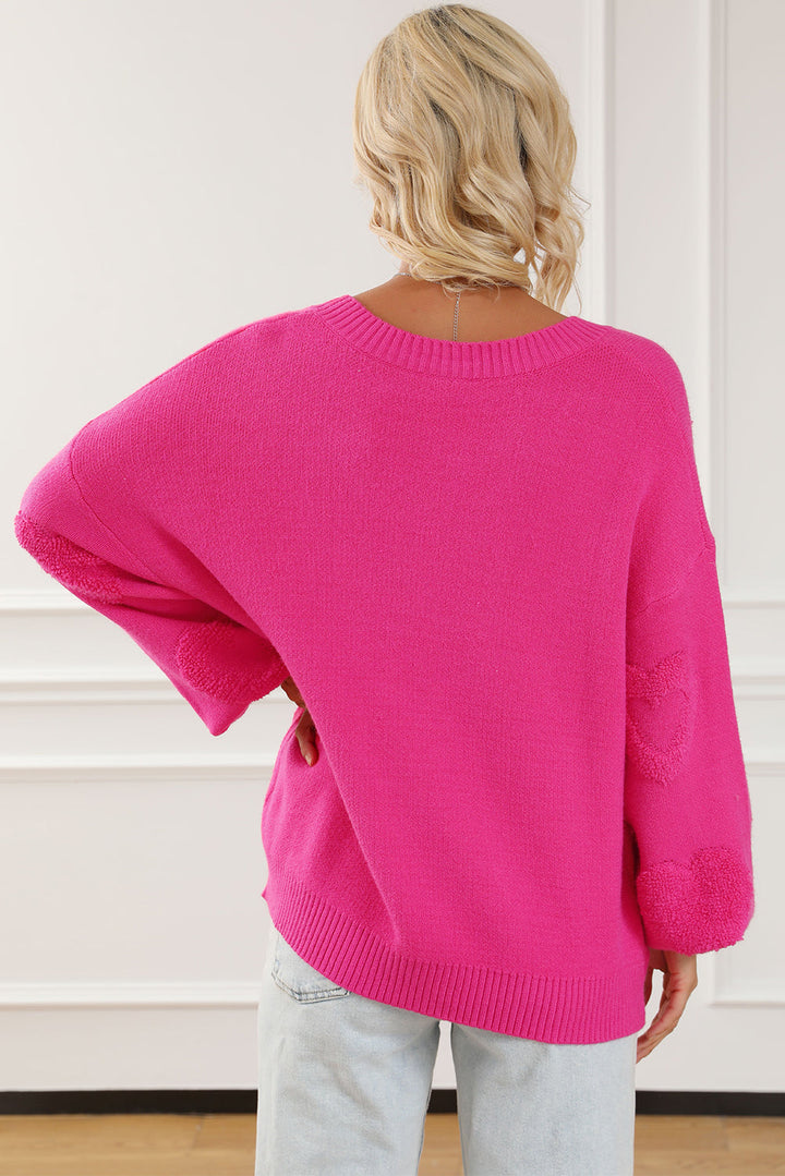 Solène – Pull rose avec col en V et détails en forme de cœur