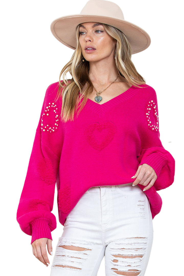 Solène – Pull rose avec col en V et détails en forme de cœur