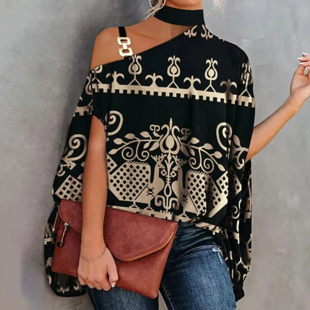 Top asymétrique femme chic – Imprimé géométrique, épaules dénudées avec détail chaîne dorée
