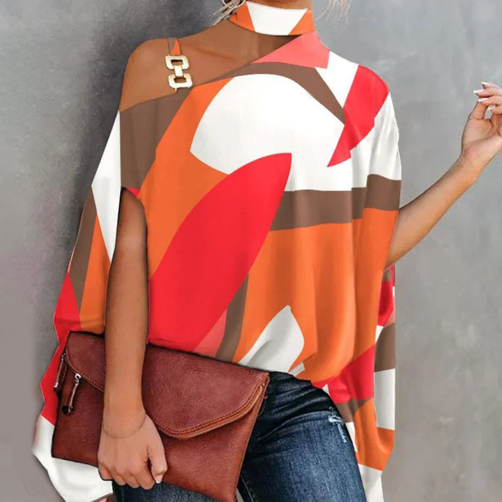 Top asymétrique femme chic – Imprimé géométrique, épaules dénudées avec détail chaîne dorée
