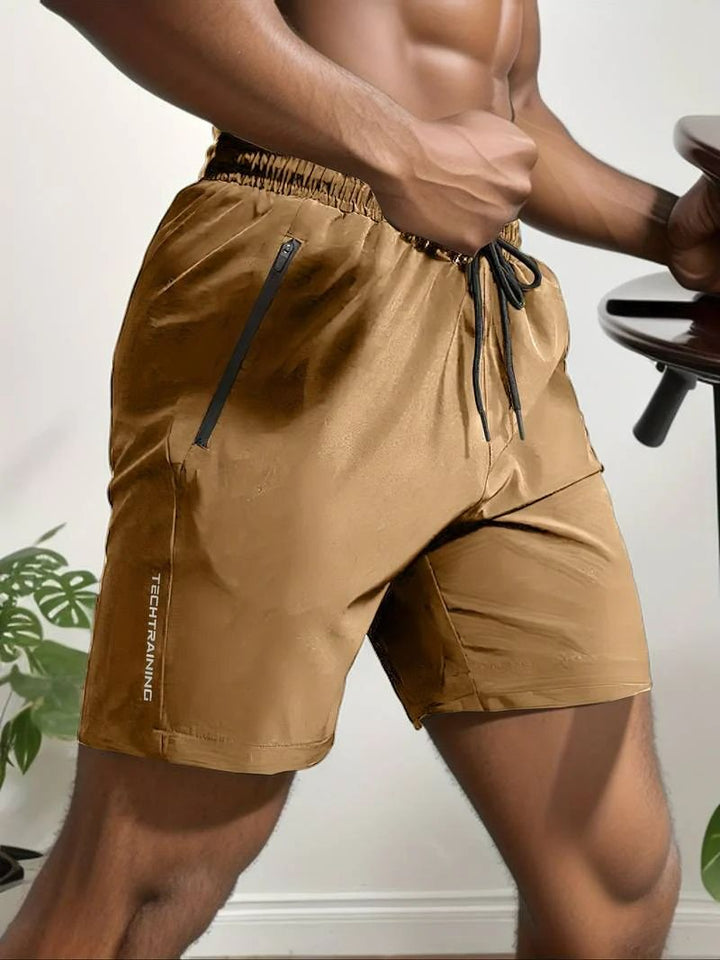 Short de sport homme TechTraining – Léger, respirant, séchage rapide avec poches zippées