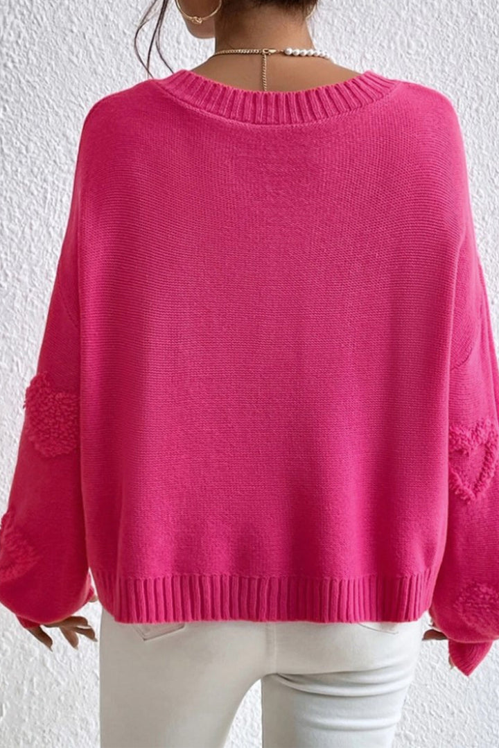 Solène – Pull rose avec col en V et détails en forme de cœur